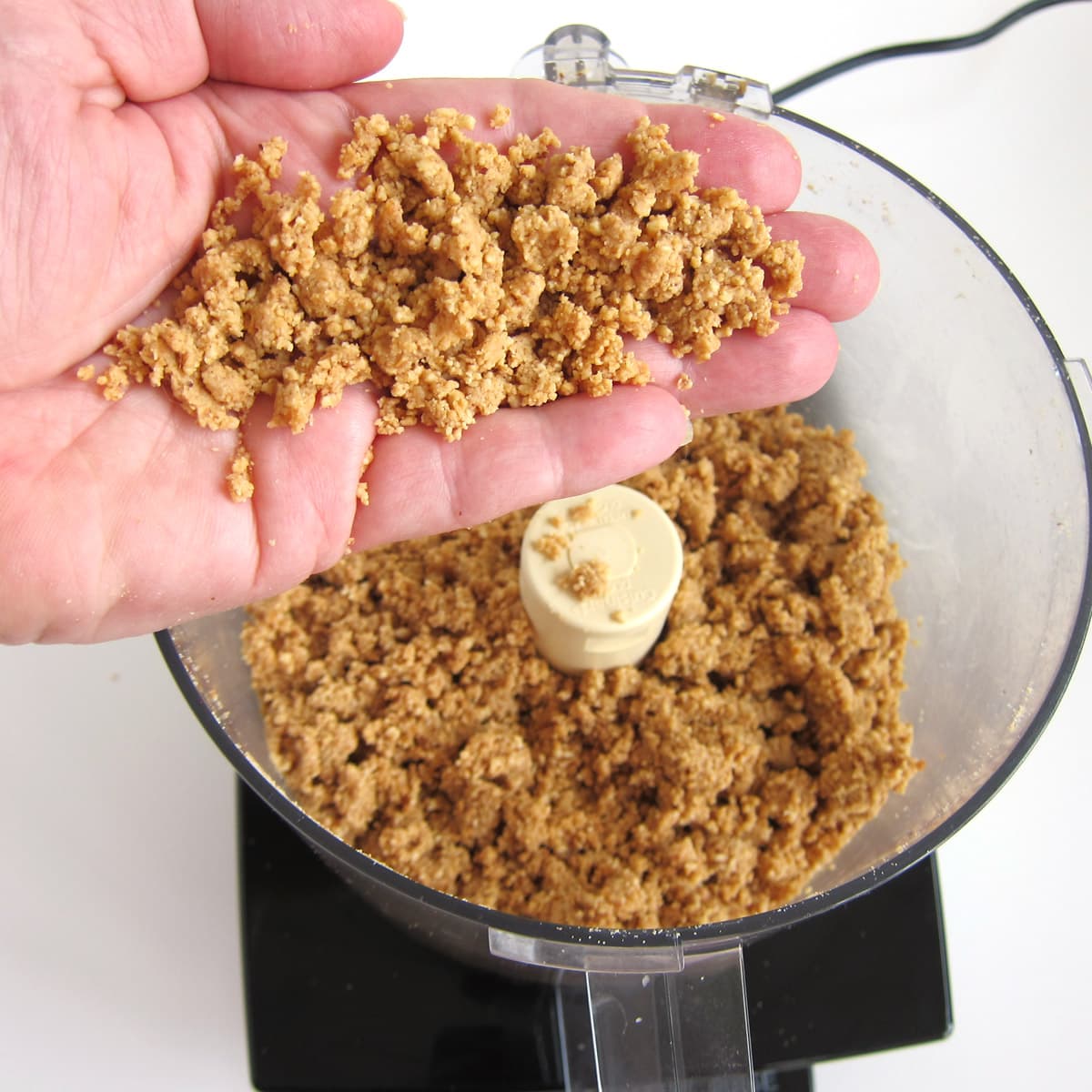 grinding peanuts into peanut butter using a food processor.