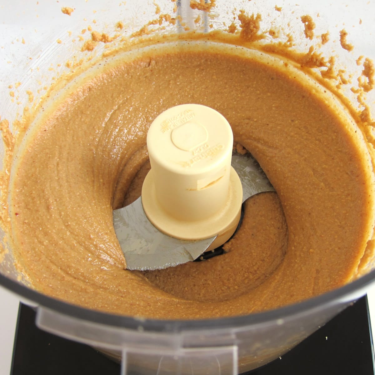 smooth and creamy homemade peanut butter made in a food processor.