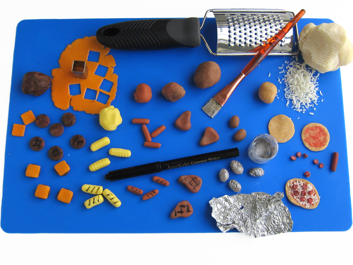 sculpting hamburgers, hot dogs, baked potatoes, corn, steaks, and pizzas out of modeling chocolate.
